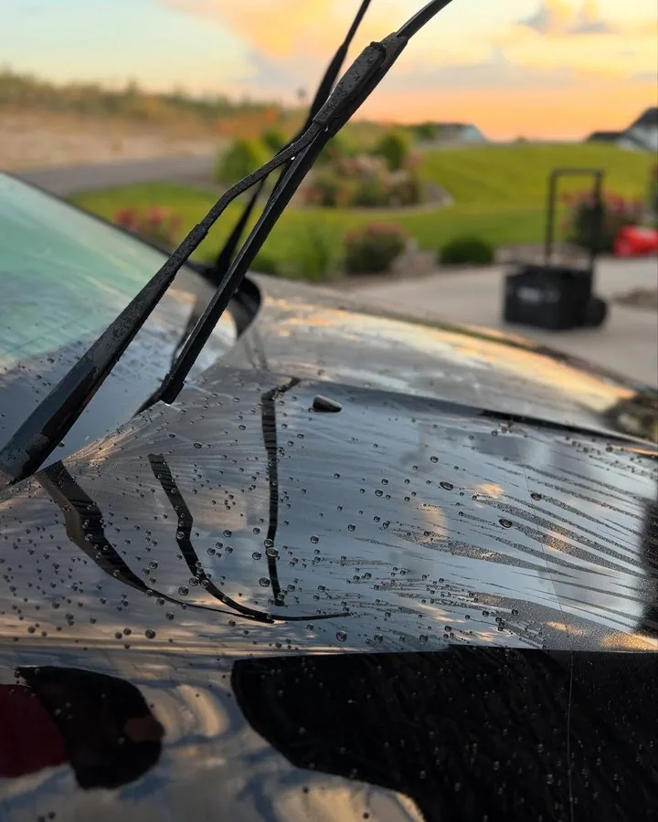 Water beading on black paint after ceramic coating in Idaho Falls