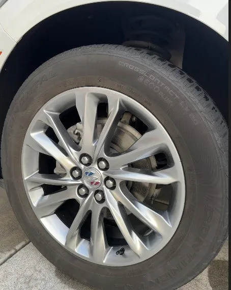Buick wheel before exterior detail in Idaho Falls — dull, brake-dusted alloy